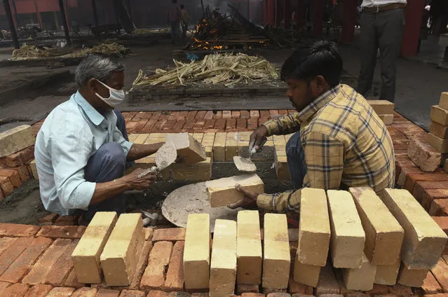 Labourers build cremation platforms to meet the increase of cremations due to the Covid-19 coronavirus pandemic at a crematorium in Amritsar on April 29, 2021. (Photo by Narinder Nanu/AFP Photo)