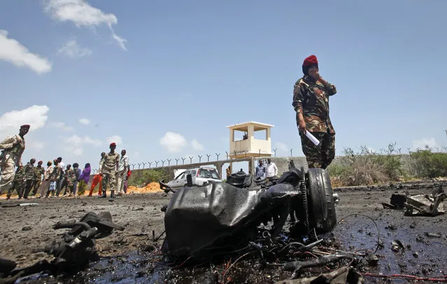 Somali security forces attend the scene after an attack on a European Union military convoy in the capital Mogadishu, Somalia Monday, October 1, 2018. A Somali police officer says a suicide car bomber has targeted a European Union military convoy carrying Italian military trainers in the Somali capital Monday. (Photo by Farah Abdi Warsameh/AP Photo)