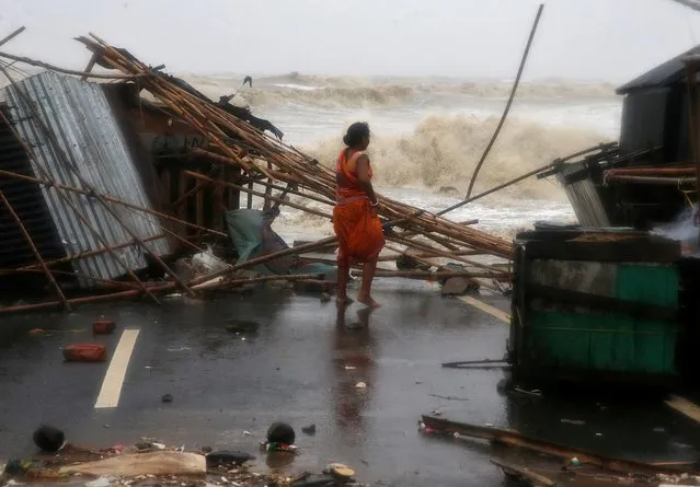 A woman stands next to her stall damaged by heavy winds at a shore ahead of Cyclone Yaas in Bichitrapur in Balasore district in the eastern state of Odisha India, May 26, 2021. (Photo by Rupak De Chowdhuri/Reuters)