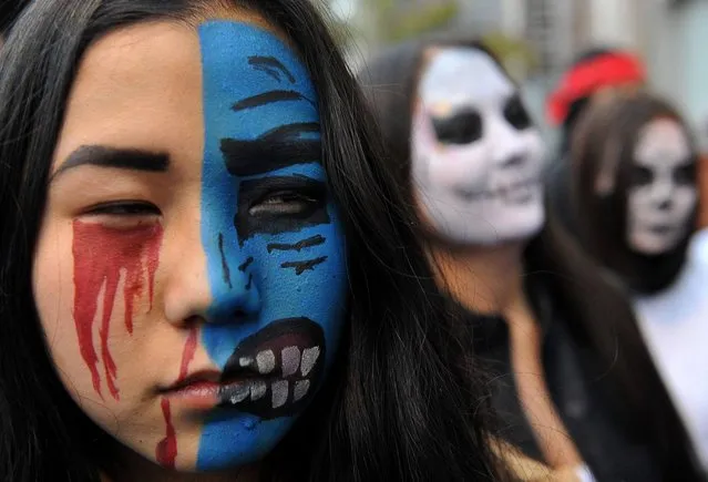 Students dressed as zombies participate in an annual Halloween party in central Bishkek, on October 31, 2013. (Photo by Vyacheslav Oseledko/AFP Photo)