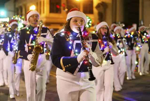 South Point's marching band passes by as Huntington's annual Christmas Parade of Lights moves down 4th Avenue Saturday, December 10, 2016, in downtown Huntington, W.Va. (Photo by Sholten Singer/The Herald-Dispatch via AP Photo)