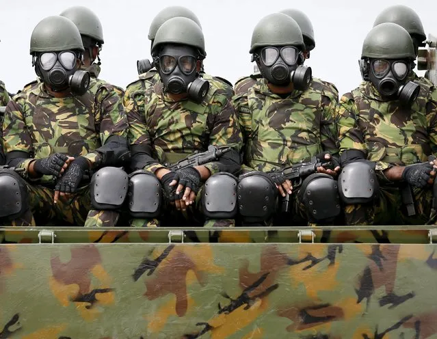 Special Task Force (STF) soldiers with gas masks sit on an armoured vehicle during a rehearsal for Sri Lanka's 68th Independence day celebrations in Colombo, February 2, 2016. (Photo by Dinuka Liyanawatte/Reuters)