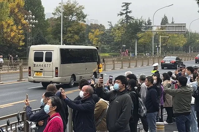 Some people use smartphones to film a vehicle with flowers which is believed to be carrying the body of former Premier Li Keqiang as the convoy heads to the Babaoshan Revolutionary Cemetery in Beijing Thursday, November 2, 2023. Hundreds, possibly thousands, of people gathered near a state funeral home Thursday as former Premier Li Keqiang was being put to rest. (Photo by AP Photo)