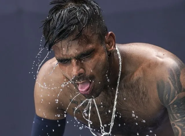 India's Sumit Nagal shakes water off after pouring water on his head to cool down during a heat break while playing a qualifying match against Uzbekistan's Denis Istomin during  the first round of the Tennis competition of the Tokyo 2020 Olympic Games at Ariake Tennis Park  on Saturday, July 24. 2021. (Photo by Toni L. Sandys/The Washington Post)
