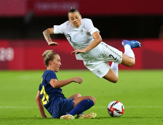 New Zealand's midfielder Ria Percival (R) is tackled by Sweden's midfielder Julia Roddar (L) during the Tokyo 2020 Olympic Games women's group G first round football match between New Zealand and Sweden at the Miyagi Stadium in Miyagi on July 27, 2021. (Photo by Amr Abdallah Dalsh/Reuters)