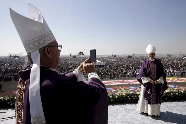 A member of the cleric takes a picture of another before a Mass celebrated by Pope Francis before a crowd of hundreds of thousands in Ecatepec, Mexico, February 14, 2016. (Photo by Max Rossi/Reuters)