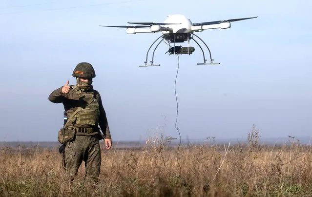 A serviceman operates a Kvazimachta hardware raising system of the Russian Central Military District in the zone of Russia's special military operation on November 3, 2022. Sibir-1 and Griffon UAVs can move along with advancing forces without moving control posts and losing connection quality. The use of communication drones allows to increase covertness and survival of communications units, as well as to set up data transmission channels in adverse terrains. UAVs can also carry out video surveillance and reconnaissance. (Photo by Stanislav Krasilnikov/TASS)