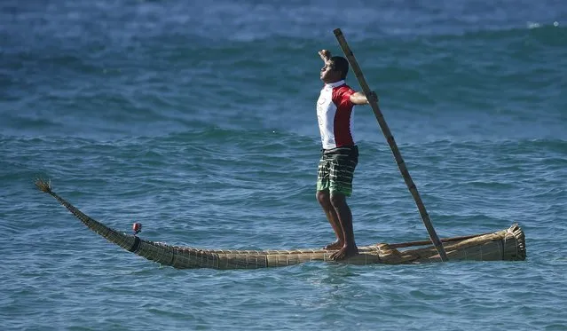 Peruvian surfer Carlos “Huevito” Areola stands up on his reed board, or “caballito” (little horse), at Sydney's Bondi Beach, February 24, 2016, during the start of an Australian tour to promote the fact that Peruvian fishermen and traders have been surfing for thousands of years. The “caballito” is thought to have been invented around 3,000 BC in northern Peru and was used by local traders and fishermen to paddle through the surf and then ride the waves back to shore. (Photo by Jason Reed/Reuters)