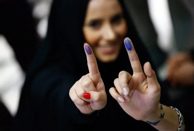 Iranians girls show the ink on their fingers, indicating they have voted, in the parliamentary and Experts Assembly election at a polling station at Ershad Mosque in Tehran, Iran, 26 February 2016. Voting began in Iran's parliamentary elections, which mark the first test of the political mood since Iran's nuclear deal with major powers reached in July. More than 4,800 candidates are running for 290 seats. (Photo by Abedin Taherkenareh/EPA)
