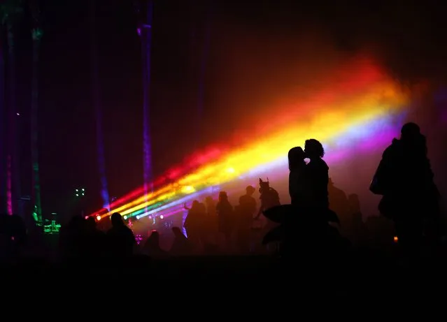 People gather beneath rainbow lights following Cinespia’s screening of “The Wizard of Oz” at Hollywood Forever Cemetery, presented by Amazon Studios & Prime Video, on July 31, 2021 in Los Angeles, California. Summer screenings have returned to the iconic cemetery after a hiatus amid the pandemic last summer. Actress Judy Garland is laid to rest at the cemetery where many movie legends are buried. (Photo by Mario Tama/Getty Images)