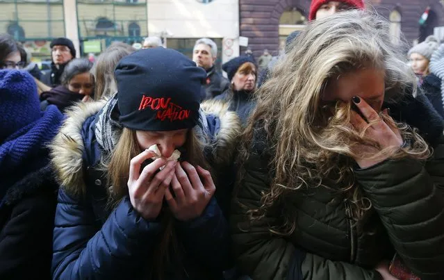 People cry in front of a school building in Budapest, Hungary January 21, 2017. Sixteen people were killed and about 40 injured after a bus carrying Hungarian students burst into flames on a highway in northern Italian city of Verona. (Photo by Laszlo Balogh/Reuters)