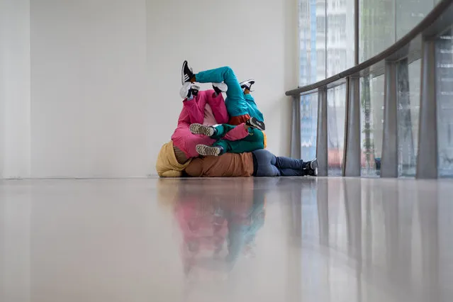 Dancers perform as human sculptures during an exhibition in Hong Kong, China, 26 March 2019. The exhibition entitled 'Multisensory Exhibition Urban Playgrounds' shows how Austrian artist Willi Dorner uses urban spaces to interpret the relationship between bodies and objects. (Photo by Jerome Favre/EPA/EFE)