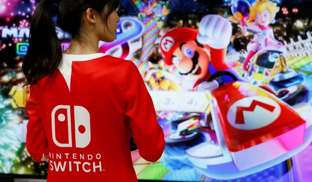 An event employee of Nintendo attends the presentation ceremony of its new game console Switch in Tokyo, Japan January 13, 2017. (Photo by Kim Kyung-Hoon/Reuters)