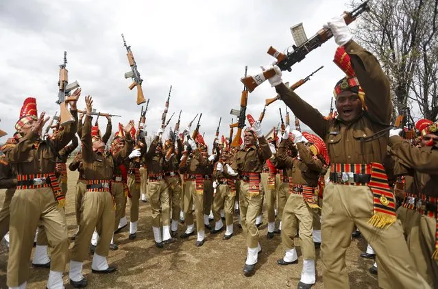 Indian Border Security Force (BSF) personnel toss their rifles to celebrate after their passing-out parade in Humhama on the outskirts of Srinagar March 14, 2016. A total of 130 recruits on Monday were formally inducted into the BSF, an Indian paramilitary force mostly deployed along the borders, after completing 44 weeks of training, a BSF media release said. (Photo by Danish Ismail/Reuters)