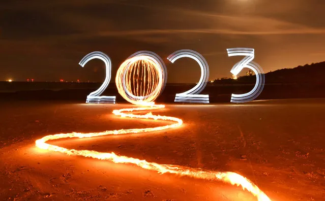2023 New Year themed photo, painting with light on Frinton beach, Frinton-on-Sea in Essex on Thursday evening, December 29, 2022. It took a team of four people to create the images with light up tubes moved around during a long exposure. A 117 second exposure. (Photo by Kevin Jay/Picture Exclusive)