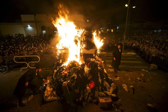 Ultra-Orthodox Jews stand around a bonfire as they celebrate the Jewish holiday of Lag Ba'Omer in Ashdod May 6, 2015. (Photo by Amir Cohen/Reuters)