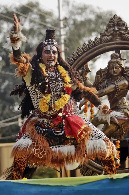 A devotee dressed as Hindu God Shiva dances as he participates in a procession on the eve of Shivratri festival, in Jammu, India, Wednesday, February 26, 2014. Shivratri, a festival dedicated to the worship of Hindu God Shiva, will be marked across the country Thursday. (Photo by Channi Anand/AP Photo)