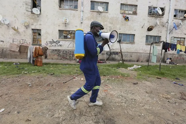 A man moves around offering fumigation services in a poor neighborhood to curb the spread of COVID-19 in Harare, Zimbabwe, Monday, November 29, 2021. The emergence of the new omicron variant and the world’s desperate and likely futile attempts to keep it at bay are reminders of what scientists have warned for months: The coronavirus will thrive as long as vast parts of the world lack vaccines. (Photo by Tsvangirayi Mukwazhi/AP Photo)