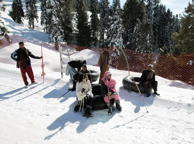 Customers and inner tube renters rest on the side of the piste at the ski resort in Malam Jabba, Pakistan February 7, 2017. (Photo by Caren Firouz/Reuters)