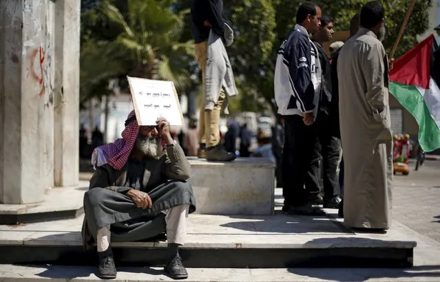 A Palestinian man rests as other take part in a protest calling for a better living condition for people, in Gaza city April 2, 2016. (Photo by Suhaib Salem/Reuters)