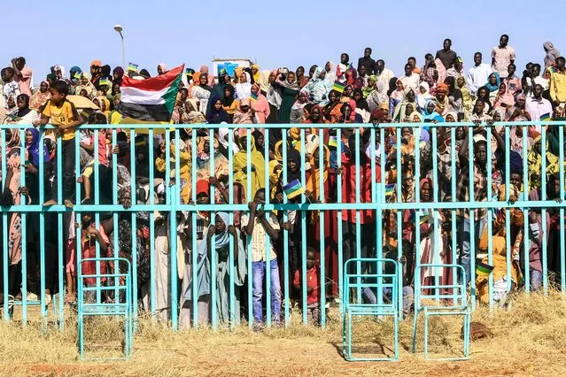 People watch as fighters of the Sudan Liberation Movement, a Sudanese rebel group active in Sudan's Darfur State which supports army chief Abdel Fattah al-Burhan, attend a graduation ceremony in the southeastern Gedaref state on March 28, 2024. Sudan's war has already killed thousands, including between 10,000 and 15,000 in a single city in the western Darfur region, according to UN experts. The war pits army chief al-Burhan against his former deputy, Mohamed Hamdan Daglo, known as Hemeti, who commands the paramilitary Rapid Support Forces (RSF). (Photo by AFP Photo)