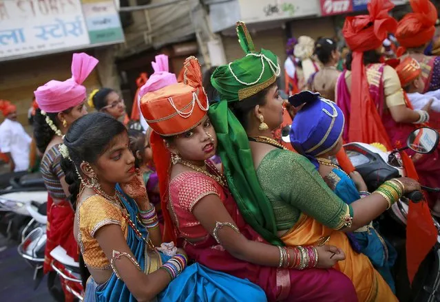 Maharashtrians dressed in traditional costumes attend celebrations to mark the Gudi Padwa festival in Mumbai, India, April 8, 2016. (Photo by Danish Siddiqui/Reuters)