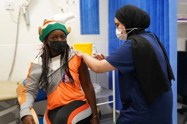 A person receives a Covid-19 vaccination as a 24-hour “jabathon” takes place at an overnight walk-in vaccine clinic at the Morris House GP practice in Haringey, United Kingdom on Friday, December 17, 2021. (Photo by Kirsty O'Connor/PA Images via Getty Images)