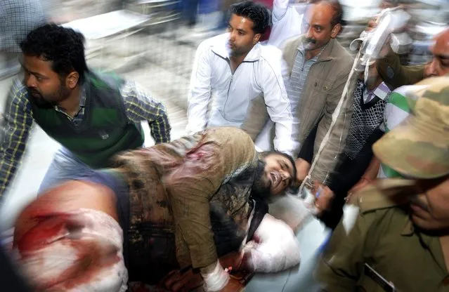An injured person of a militant attack is being taken to the Government Medical College hospital in Jammu, India, March 28, 2014. One person was killed and three others were injured after a terror attack in Dayalachak in Kathua. (Photo by Jaipal Singh/EPA)