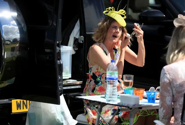 One woman touches up her makeup to be on top form on day four of Royal Ascot at Ascot Racecourse on June 21, 2019 in Ascot, England. (Photo by PA Wire Press Association)