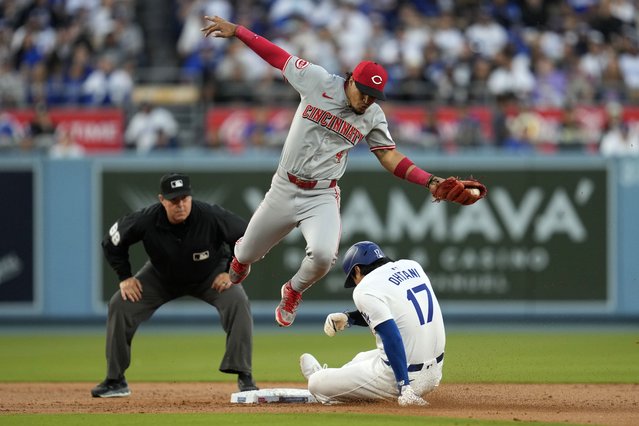 Los Angeles Dodgers designated hitter Shohei Ohtani (17) steals second base ahead of a throw to Cincinnati Reds second baseman Santiago Espinal (4) during the first inning of a baseball game in Los Angeles, Thursday, May 16, 2024. (Photo by Ashley Landis/AP Photo)
