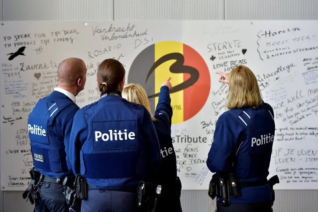 Police officers stand in front of a tribute to the victims in the departure hall after a ceremony at Brussels Airport as it reopens 40 days after deadly attacks in Zaventem, Belgium, May 1, 2016. (Photo by Eric Vidal/Reuters)