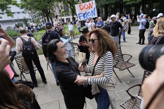 People react to the guilty verdict announced against former President Donald Trump outside Manhattan Criminal Court, Thursday, May 30, 2024, in New York. (Photo by Julia Nikhinson/AP Photo)