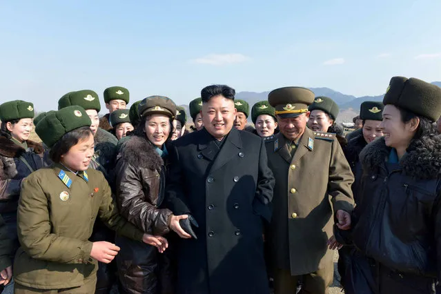 This undated picture released by North Korea's official Korean Central News Agency (KCNA) on March 7, 2014 shows North Korean leader Kim Jong-Un (C) inspecting the Korean People's Army (KPA) Air and Anti-Air Force Unit 2620 honored with the Title of O Jung Hup-led 7th Regiment at an undisclosed location in North Korea. (Photo by AFP Photo/KCNA via KNS)
