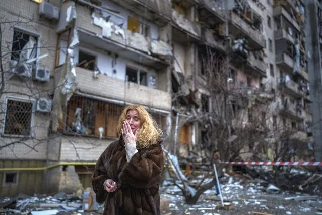 Natali Sevriukova reacts next to her house following a rocket attack in the city of Kyiv, Ukraine, Friday, February 25, 2022. (Photo by Emilio Morenatti/AP Photo)