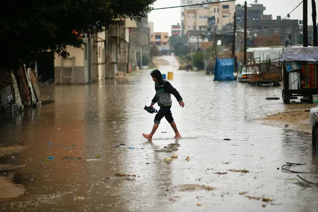 A Palestinian walks through flood water following heavy rain in a neighbourhood in the northern Gaza Strip February 16, 2017. (Photo by Mohammed Salem/Reuters)
