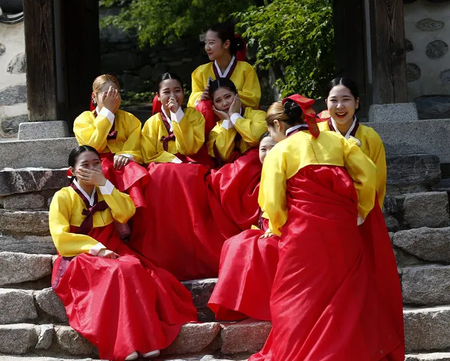 Twenty-year-old South Korean women wearing traditional costumes pose for photographs prior to the 44th Coming-of-Age Day ceremony at Namsangol Hanok Village in Seoul, South Korea, 16 May 2016. The ceremony marks boys and girls as independent individuals after living under the protection of their families. (Photo by Jeon Heon-Kyun/EPA)