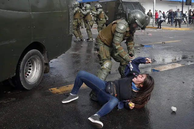Members of Chilean police arrest a student during a protest in Santiago, Chile, 09 May 2017. Students are demanding free quality public education and an end to education credit schemes that benefit banks and drag students into major debit. (Photo by Mario Ruiz/EPA)