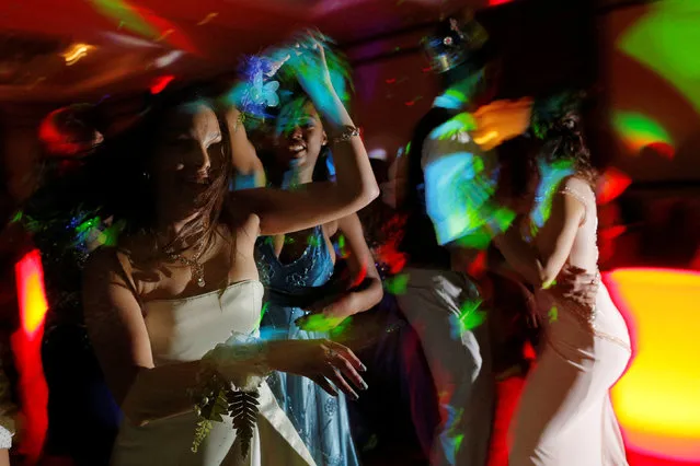 Precious Perez, 18, who has been blind since birth, dances with her friend Maddy Wilson (R) at the Chelsea High School Prom in Boston, Massachusetts, United States May 21, 2016. Precious Perez slipped into her full-length strapless prom gown and said it made her feel like storybook royalty, an experience shared by many of her peers at high schools across the United States. Blind since birth, Perez, could not see the dress's mint green colour, but said that didn't limit her ability to enjoy the formal dance, a common rite of passage for American teens. (Photo by Brian Snyder/Reuters)
