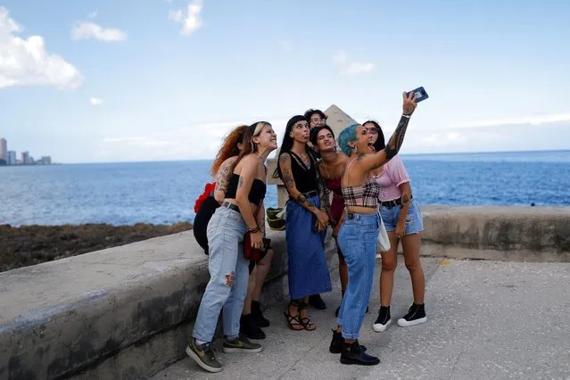 Women with tattoos pose for a selfie in Havana, Cuba, February 27, 2022. (Photo by Amanda Perobelli/Reuters)