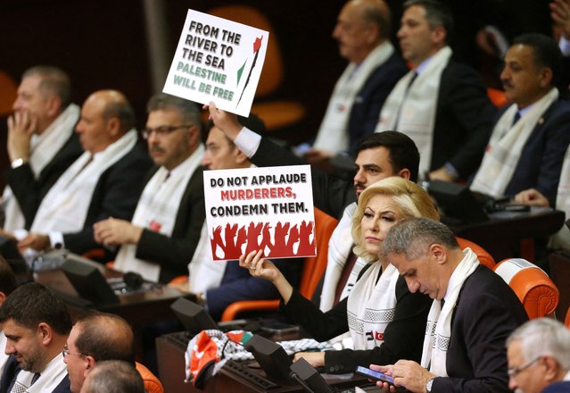 Turkey's ruling AK Party lawmakers display placards as Palestinian President Mahmoud Abbas (not pictured) addresses the Turkish parliament in Ankara, Turkey on August 15, 2024. (Photo by Cagla Gurdogan/Reuters)