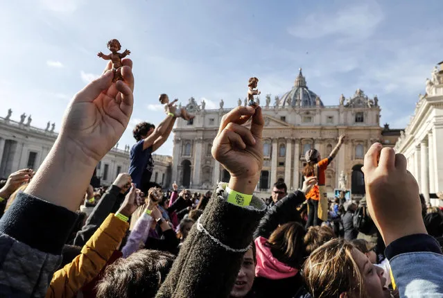 Children with statuine of Jesus for the Crib as Pope Francis leads Sunday Angelus prayer from the window of his office overlooking Saint Peter's Square at the Vatican City, 15 December 2019. (Photo by Riccardo Antimiani/EPA/EFE)