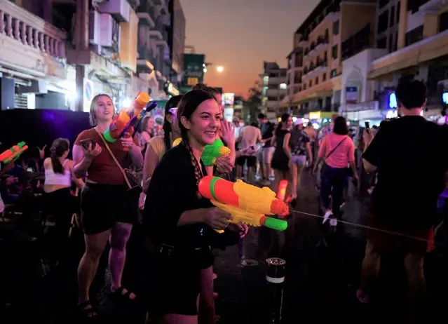 Tourists and local people play with water during the Songkran holiday which marks the Thai New Year during the coronavirus disease (COVID-19) outbreak, in Bangkok, Thailand, April 13, 2022. (Photo by Soe Zeya Tun/Reuters)