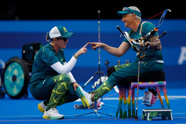 Amanda Jennings of Australia (left) finger bumps with her coach during her women’s individual recurve match against Elisabetta Mijno of Italy at Stade de France, Saint-Denis, France on September 3, 2024. (Photo by Maria Abranches/Reuters)