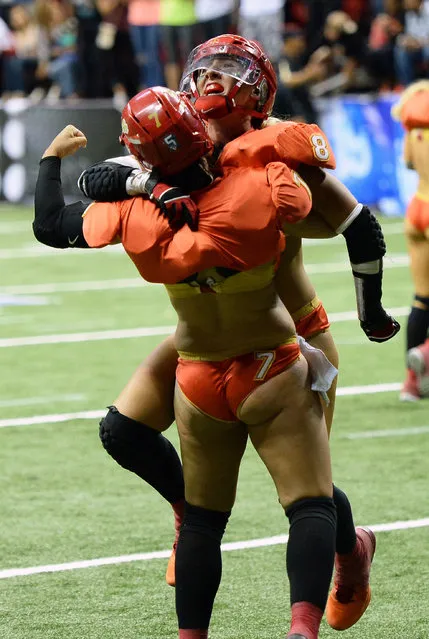 Quarterback Sindy Cummings #7 of the Las Vegas Sin celebrates with teammate Danika Brace #8 after they defeated the Green Bay Chill 34-24 at the Thomas & Mack Center on May 15, 2014 in Las Vegas, Nevada. (Photo by Ethan Miller/Getty Images)