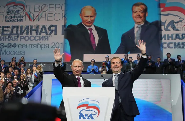 Russian President Dmitry Medvedev, right, and Prime Minister Vladimir Putin wave during a United Russia party congress in Moscow, Saturday, September 24, 2011. Russia's dominant political party on Saturday nominated Vladimir Putin for president, almost certainly ensuring his return to the office he held for eight years, and approved Putin's proposal that current president Dmitry Medvedev swap places and become prime minister. (Photo by Yekaterina Shtukina/AP Photo/RIA Novosti/Presidential Press Service)