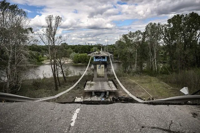 A picture taken on May 22, 2022, shows the destroyed bridge connecting the city of Lysychansk with the city of Severodonetsk in the eastern Ukranian region of Donbass, amid Russian invasion of Ukraine. (Photo by Aris Messinis/AFP Photo)