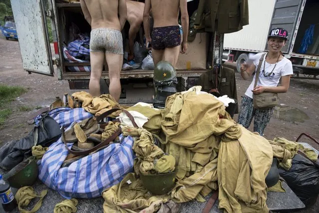 Actors get undressed in front of the costume truck at the end of the day's filming of “The Last Prince” television series at Hengdian World Studios near Hengdian July 23, 2015. (Photo by Damir Sagolj/Reuters)