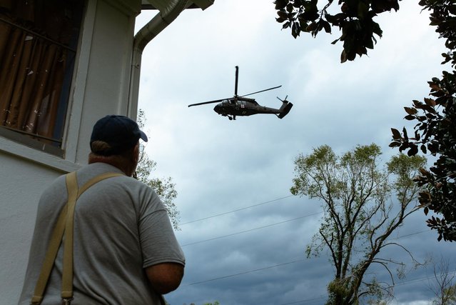 Houston Woody watches a rescue helicopter take off Saturday from Woodlawn, N.C. on September 28, 2024. (Jesse Barber/The Washington Post)