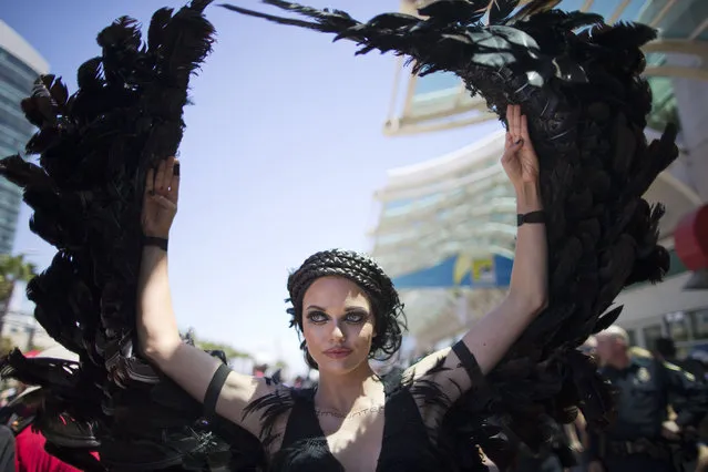 A woman dressed as the character Katniss Everdeen from the movie, “The Hunger Games: Catching Fire”, poses in front of Comic-Con Thursday, July 24, 2014, in San Diego. (Photo by AP Photo)