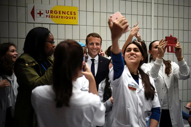 French President Emmanuel Macron (C) poses for a selfie with medical staff members as he visits the Robert-Debre pediatric hospital in Paris, France, August 9, 2017. (Photo by Philippe Lopez/Reuters)